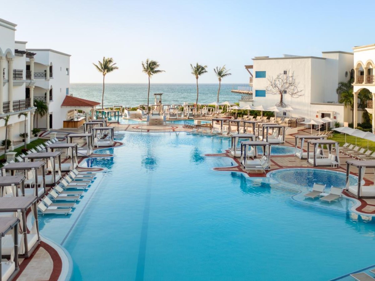 Long freshwater pool lined with loungers at Hyatt Vivid Playa del Carmen