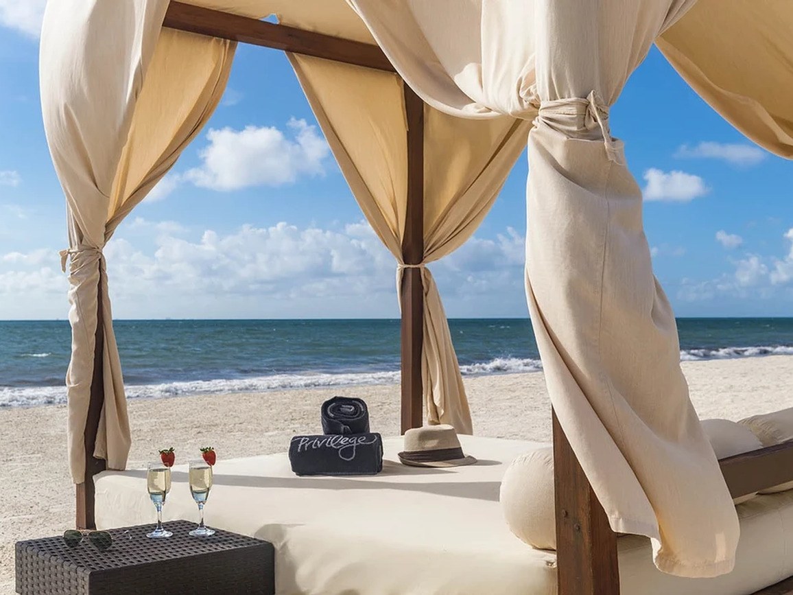 Curtained Bali bed on the Privilege beach at Ocean Maya Royale