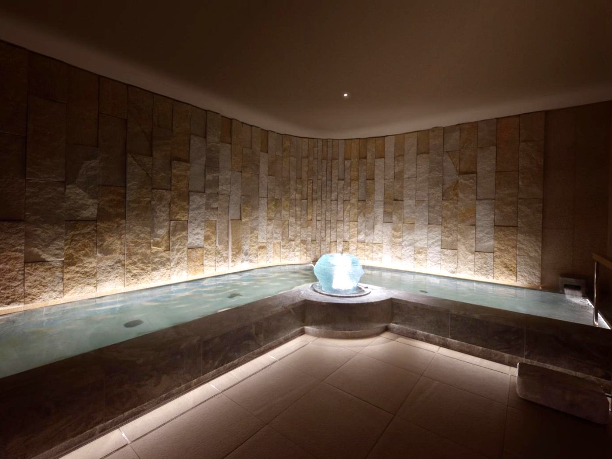 Stone-walled natural hot spring bath in the basement spa at Espacio Nagoya Castle