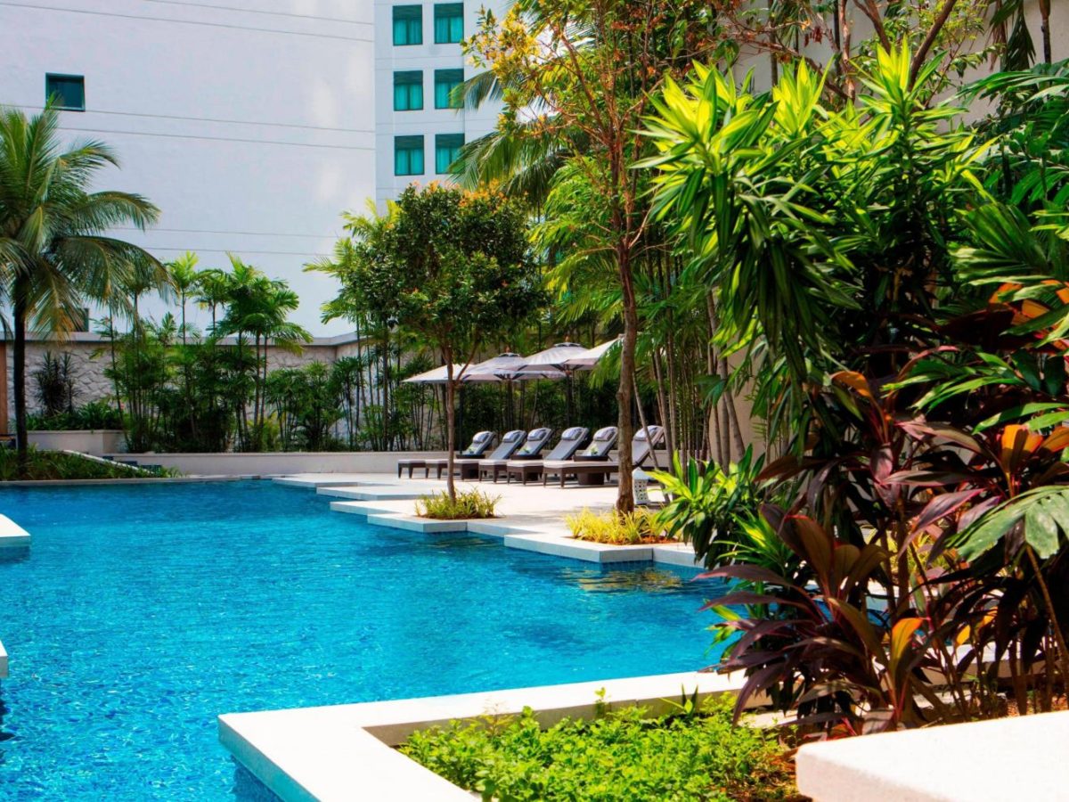 Outdoor pool set among tropical plants at The Ritz-Carlton Kuala Lumpur