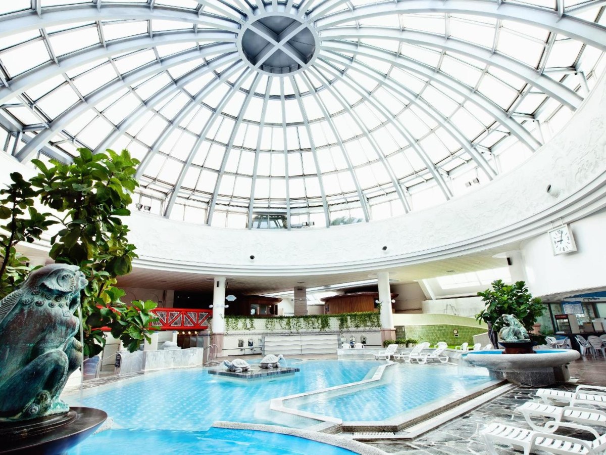Glass-domed hot spring bath hall at Heosimcheong Spa next to Hotel Nongshim