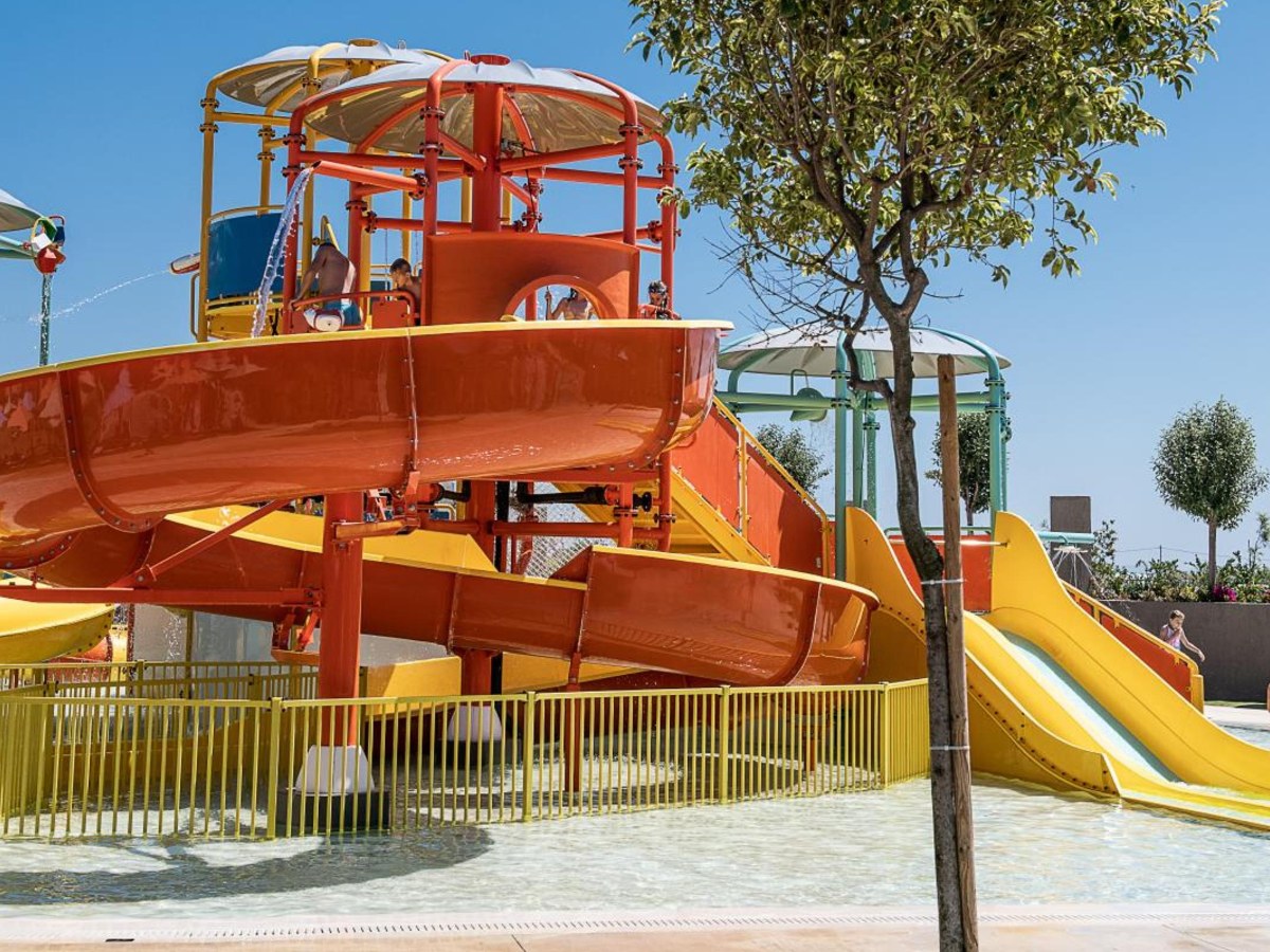 Orange slide tower and tube slides at the kids water area of Euphoria Resort in Kolymbari, Crete