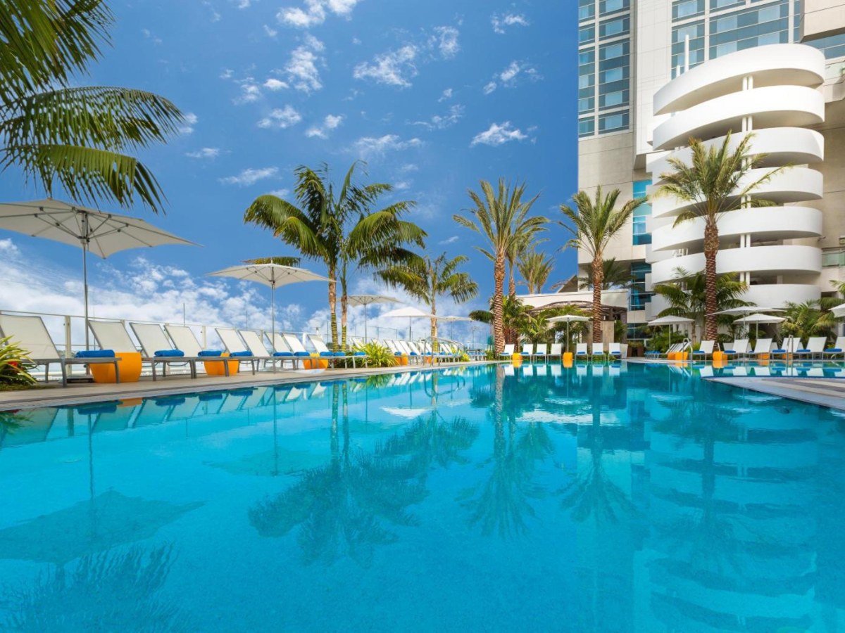 Palm-lined pool deck at Hilton San Diego Bayfront under a blue sky