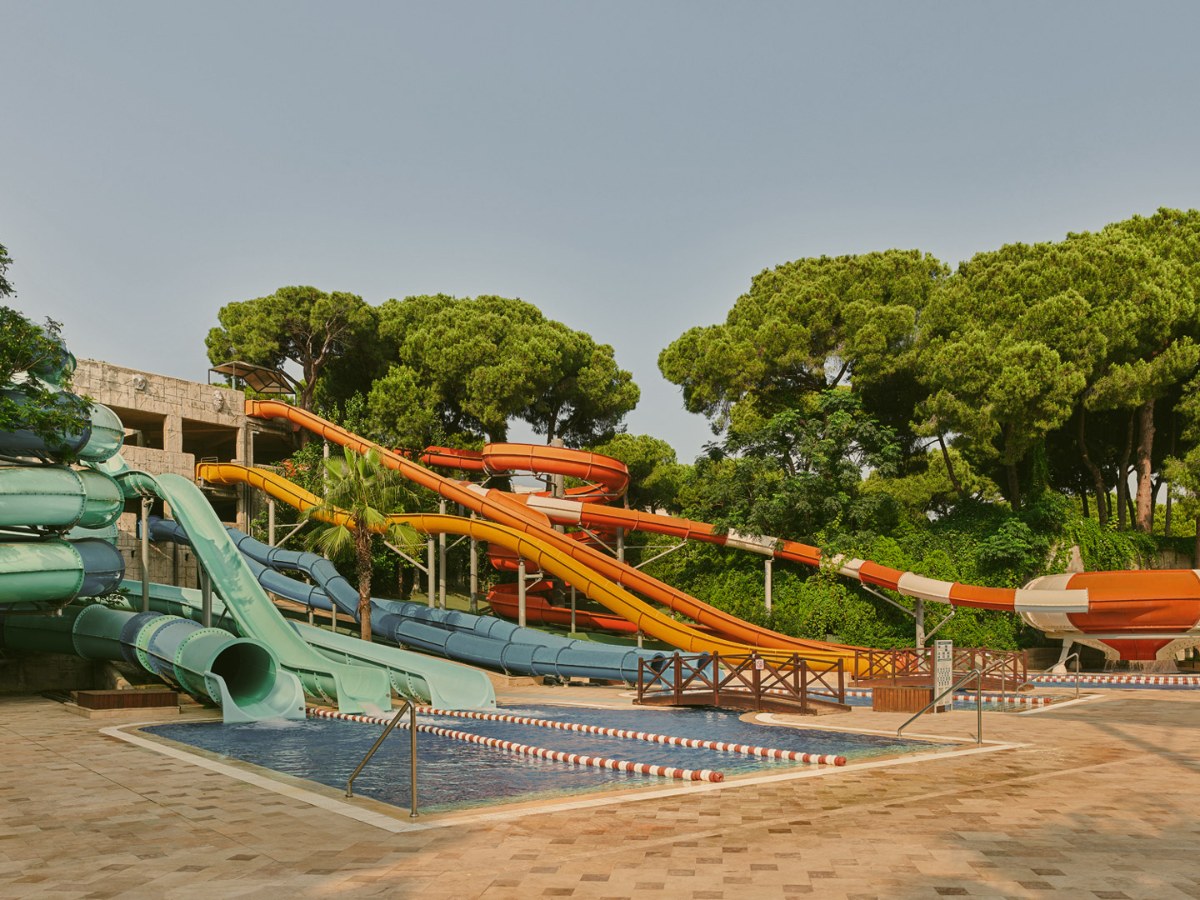 Slide tower and tube slides among pines at Maxx Royal Belek Golf Resort