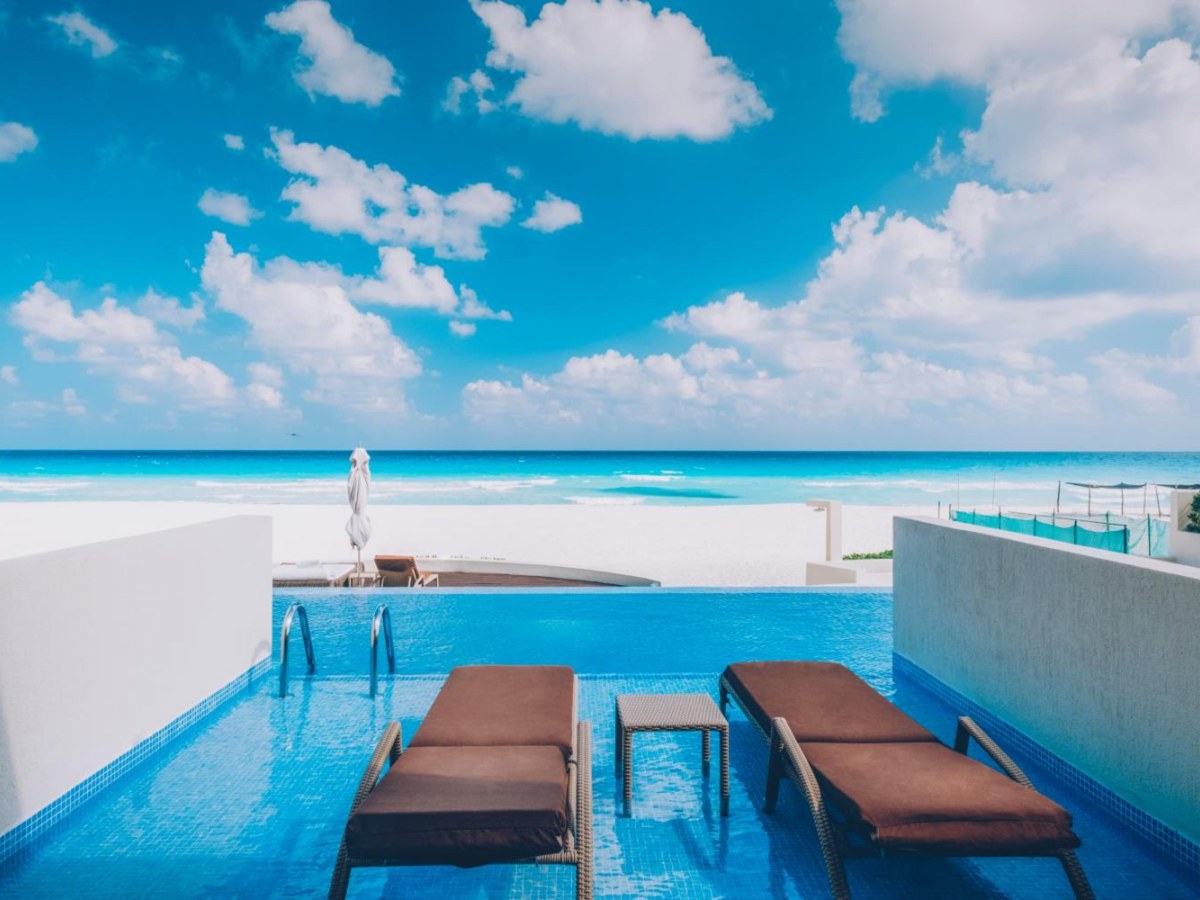 In-pool loungers on a swim-out villa terrace facing the sea at Iberostar Selection Cancun