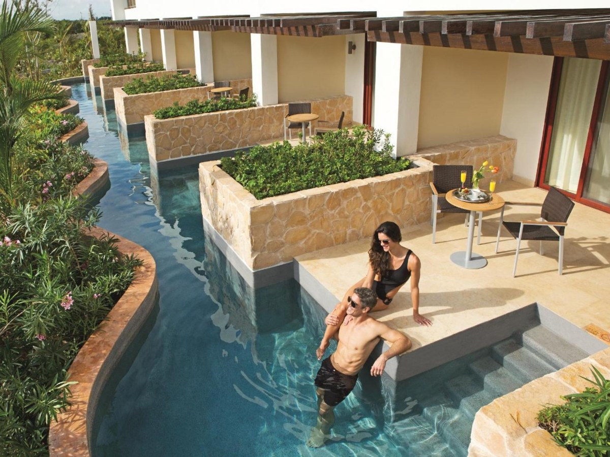 Swim-out pool channel below the junior suite terraces at Secrets Playa Mujeres