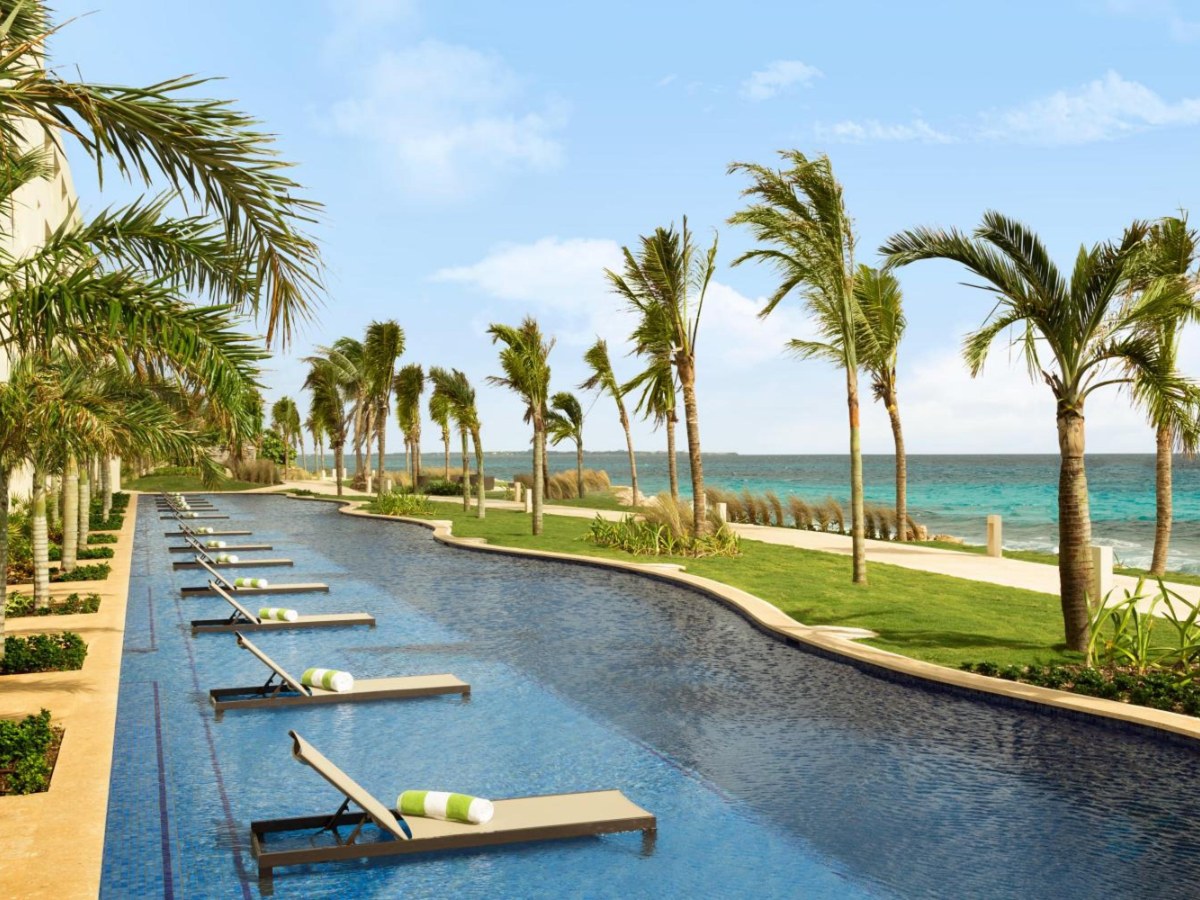Swim-up channel lined with terraces and loungers at Hyatt Ziva Cancun