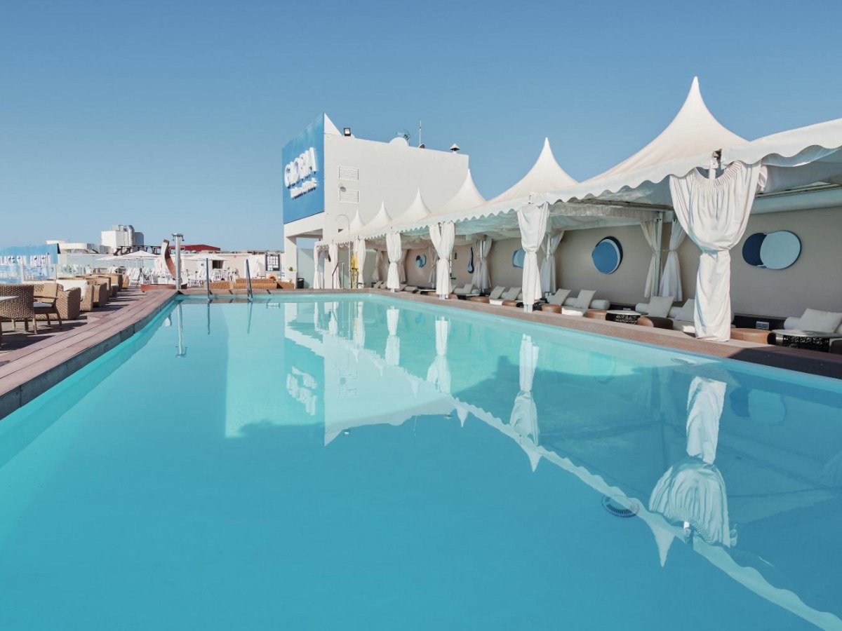 Rooftop pool under white sail canopies at Gloria Palace San Agustín