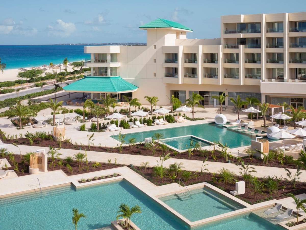Aerial view of the pools and the resort towers at JOIA Aruba by Iberostar