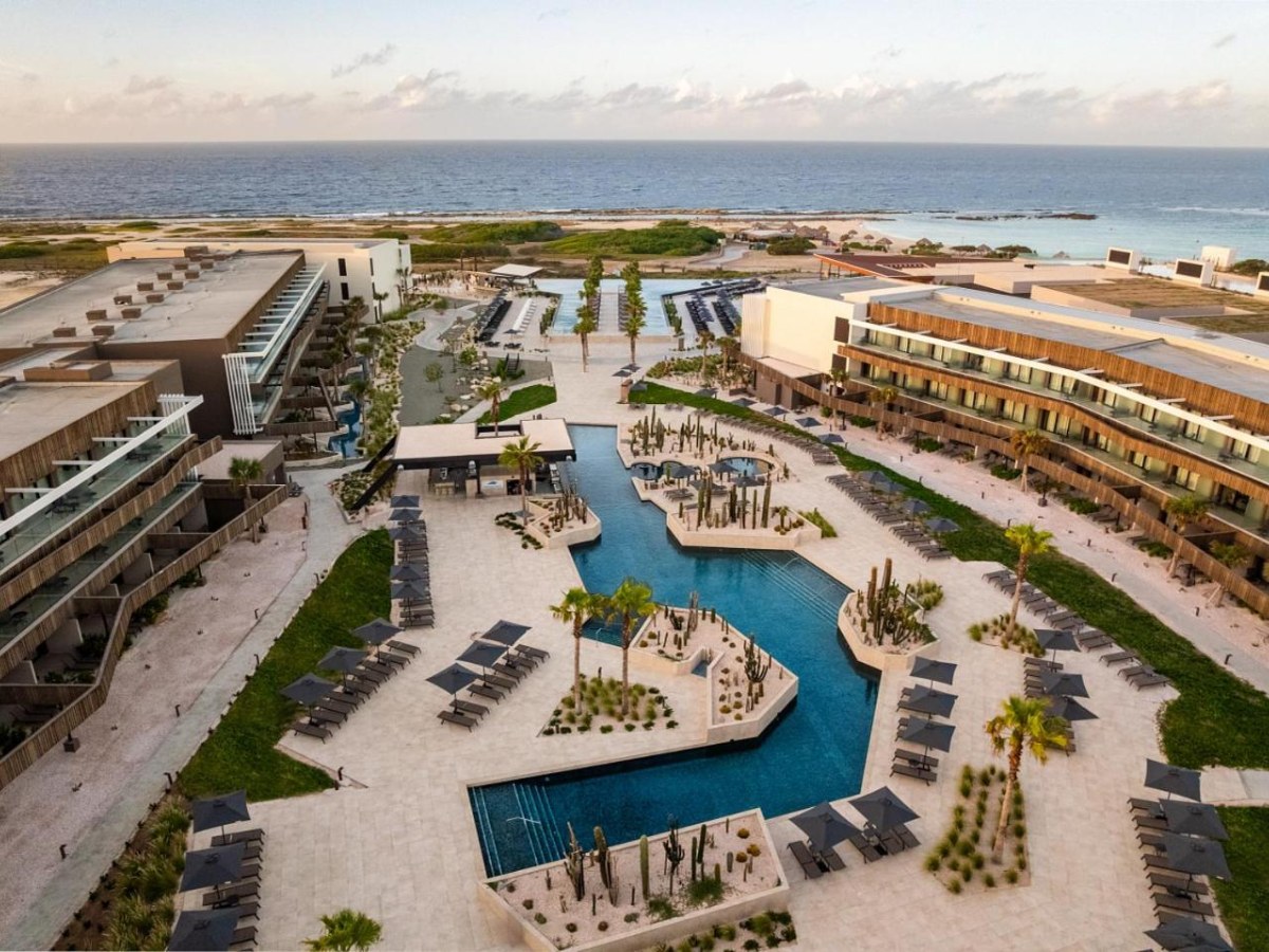 Aerial view of the pool and suites beside the sea at Secrets Baby Beach Aruba