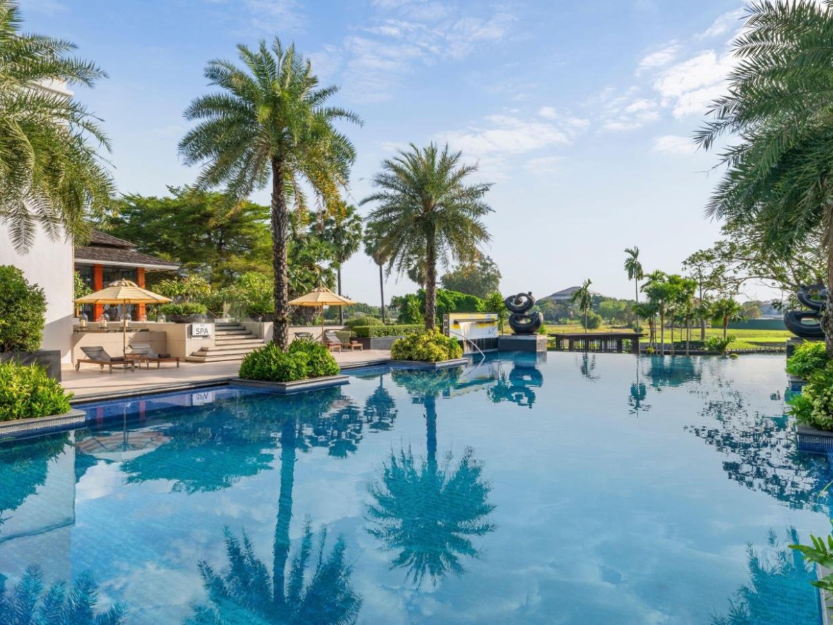 Infinity pool among palm trees at Hilton Bangkok Suvarnabhumi Golf Resort and Spa