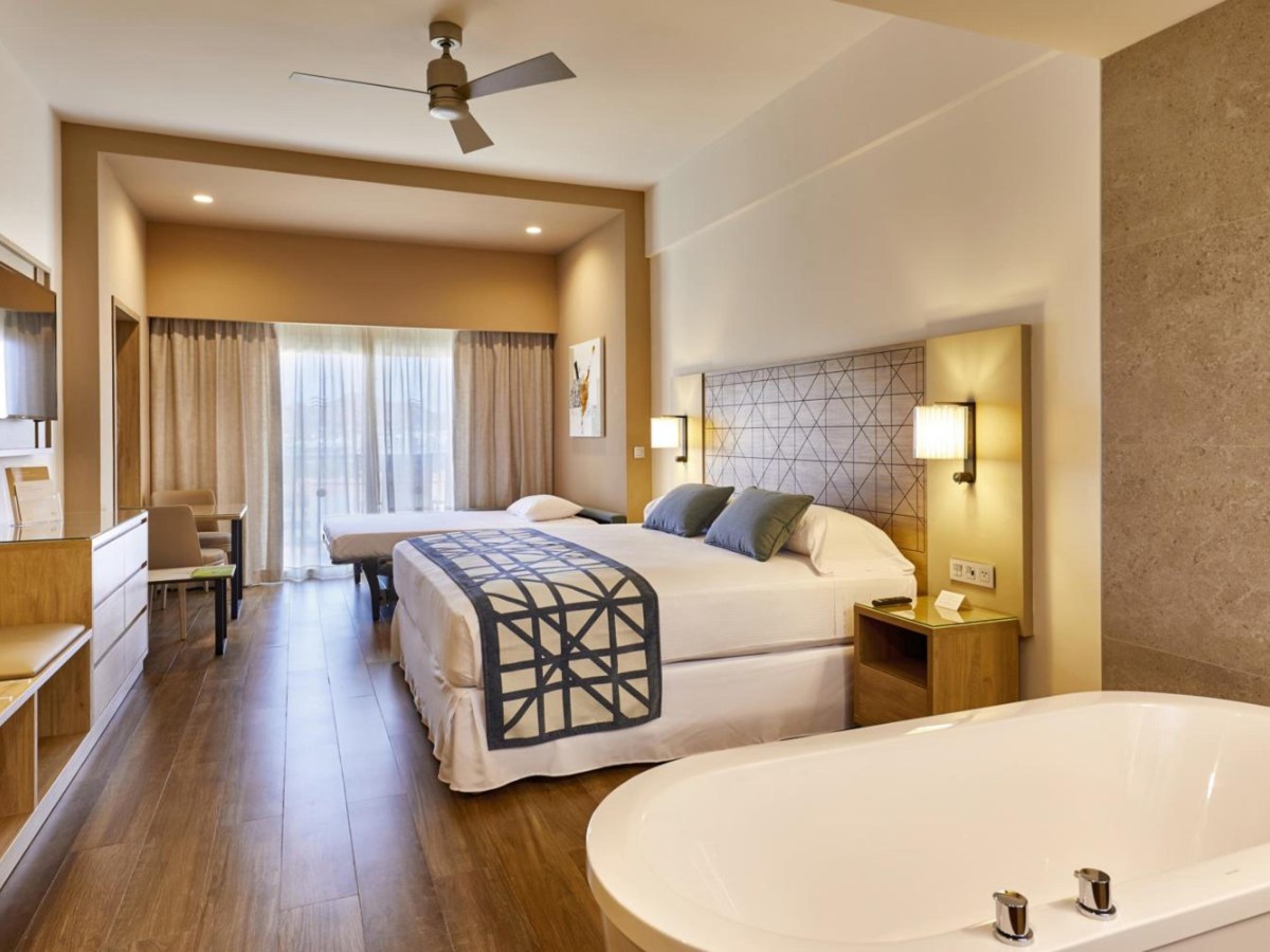 Junior suite bedroom with a bathtub at Riu Palace Baja California
