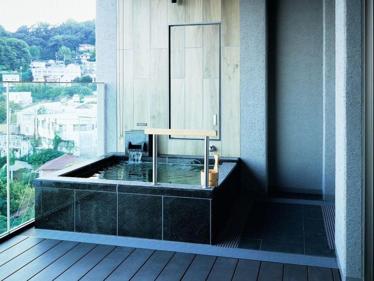 Open-air stone bath on the terrace of an Atami Izusan Karaku room