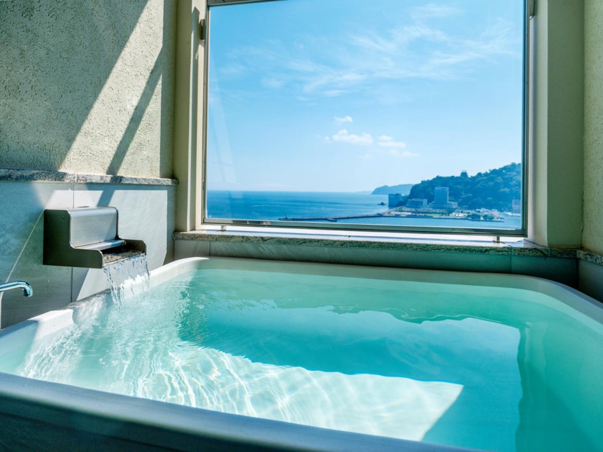 Open-air hot spring bath beside the sea window in a La Vista Atami Terrace room
