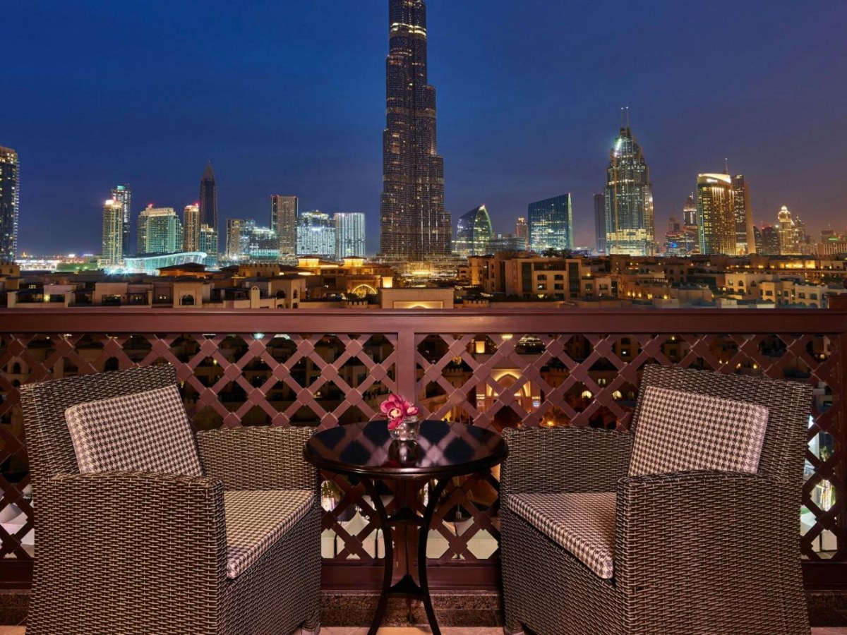 Suite balcony at The Heritage Hotel facing the lit Burj Khalifa at night