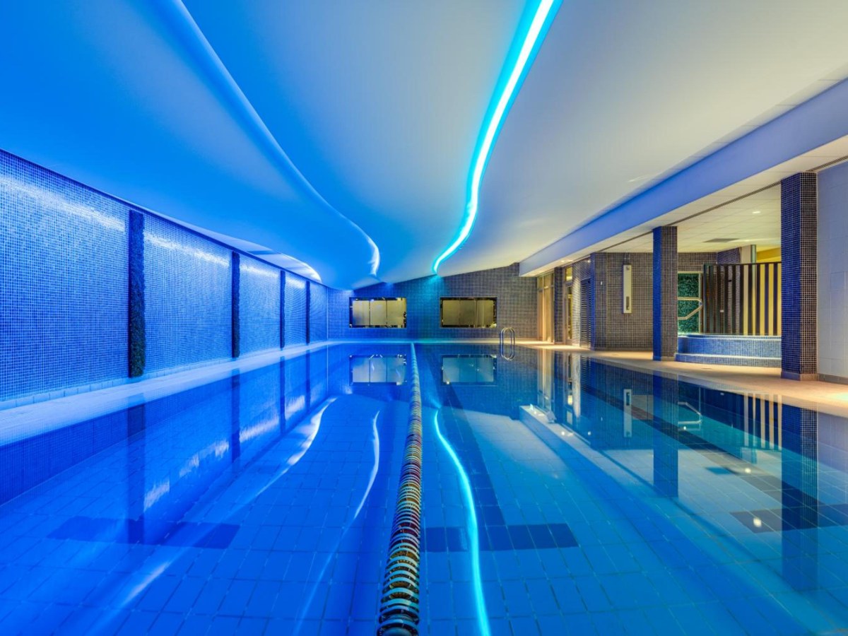 Indoor pool lit in blue in the health club at The Spencer Hotel