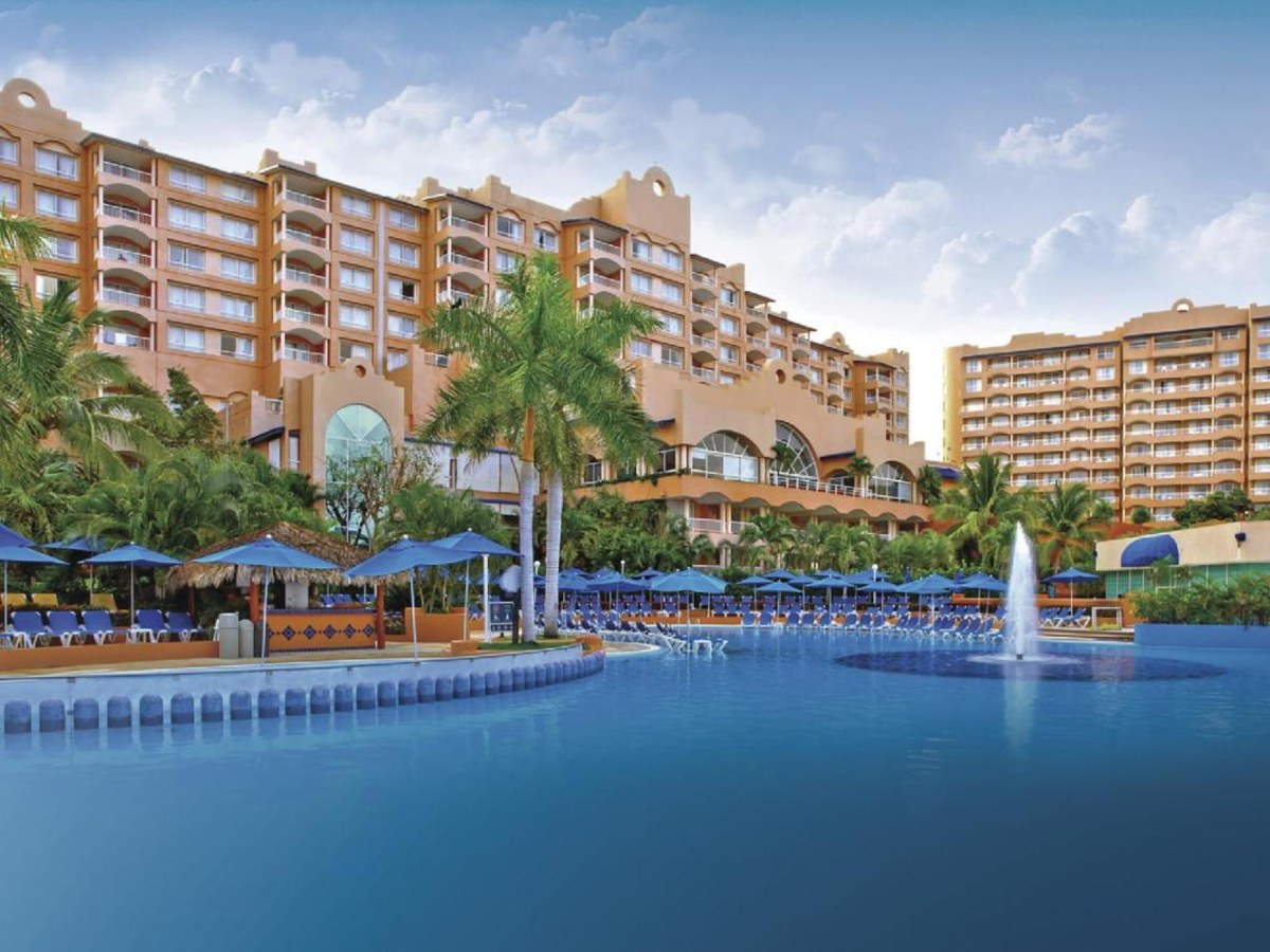 Large pool with chairs and umbrellas at Azul Ixtapa All Inclusive Resort