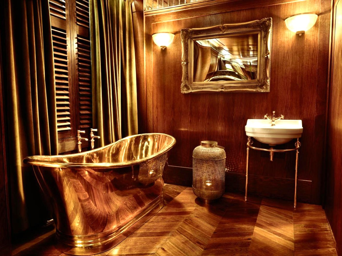 Gold roll-top bath in the bedroom of The Suite at House of Gods Glasgow