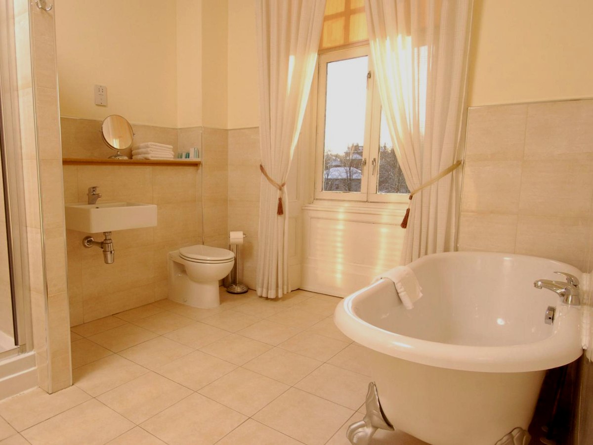 Roll-top bath in a Junior Suite bathroom at Sherbrooke Castle Hotel