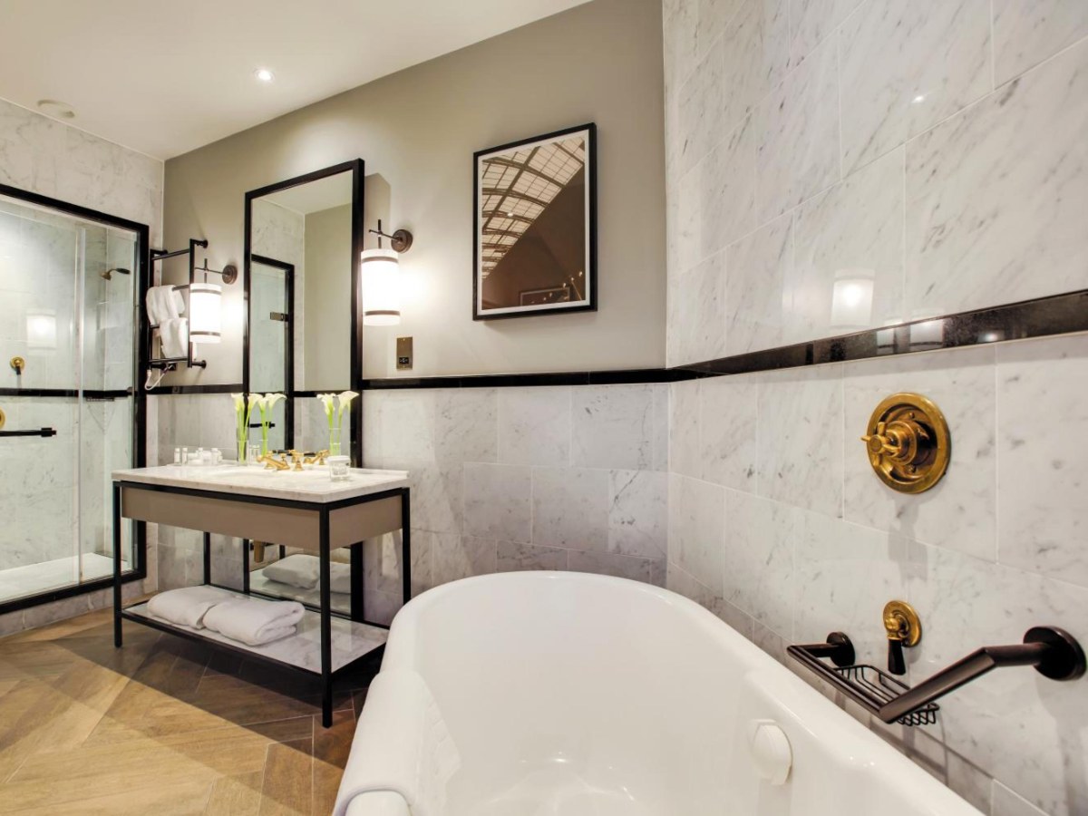 Roll-top bath in a marble bathroom at voco Grand Central Glasgow