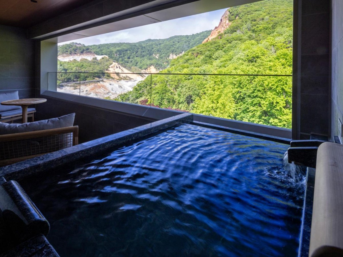 Open-air hot spring bath in a West Building Premium Twin at Dai-ichi Takimotokan