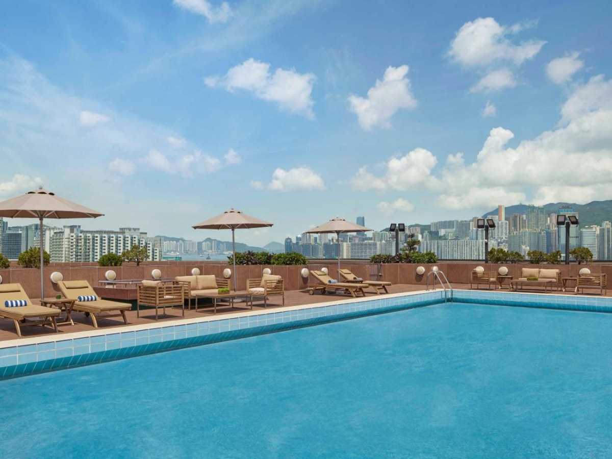 New World Millennium Hong Kong rooftop pool with loungers under open sky