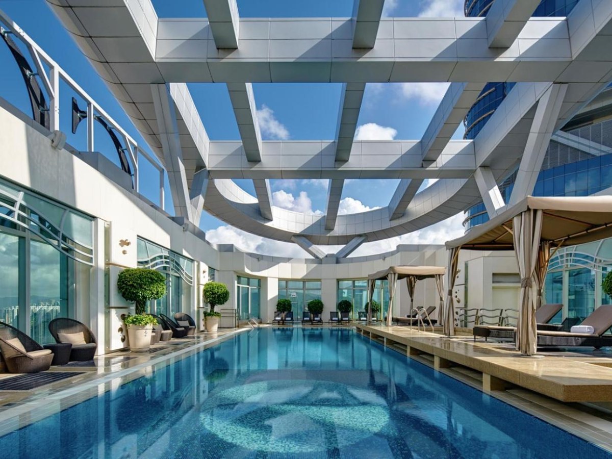 Cordis Hong Kong rooftop pool under a glass pergola