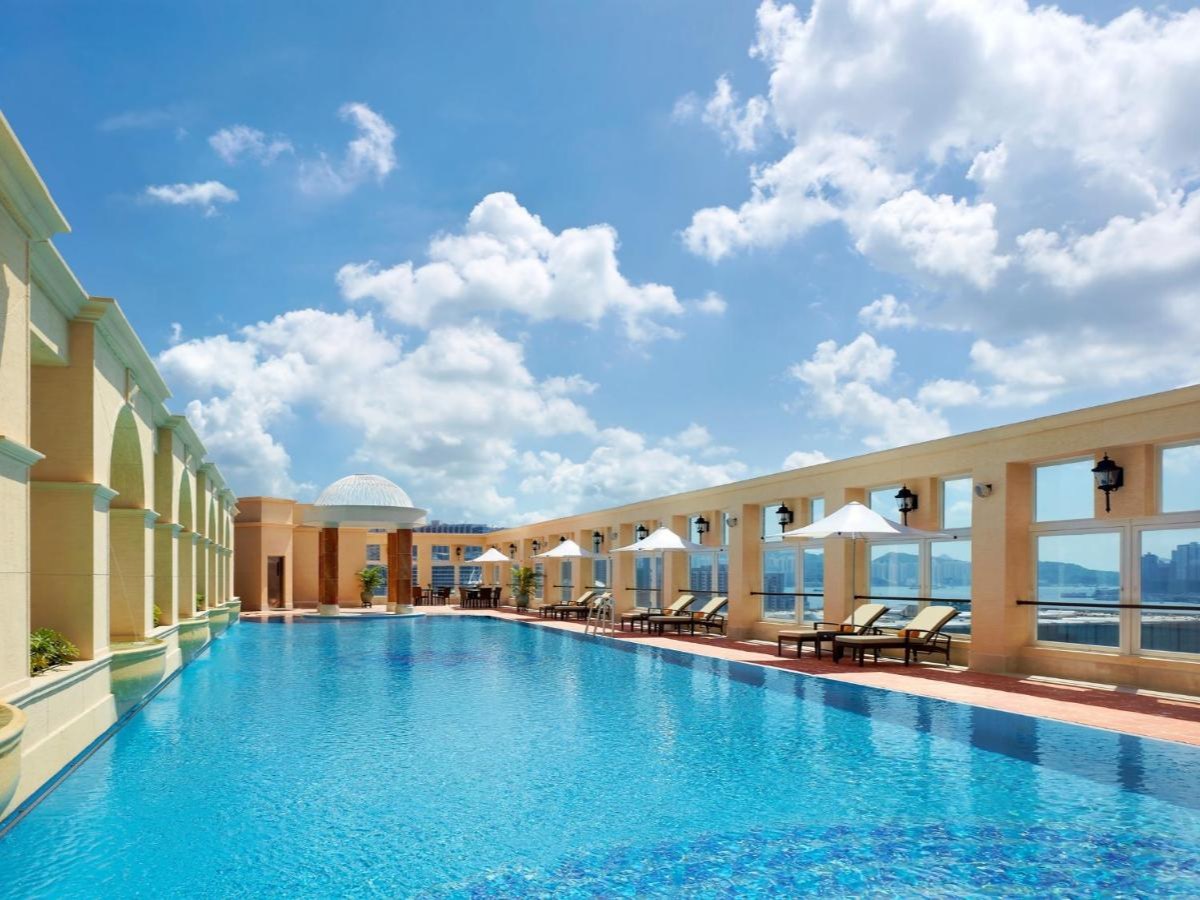 The Royal Garden Tsim Sha Tsui rooftop pool with a colonnade and open sky