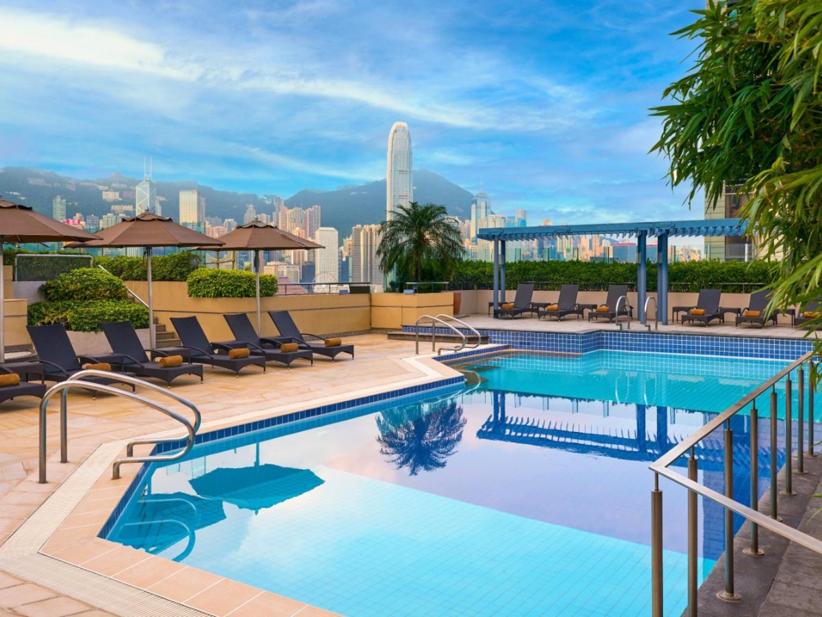 Sheraton Hong Kong pool deck with the skyline and mountains behind it