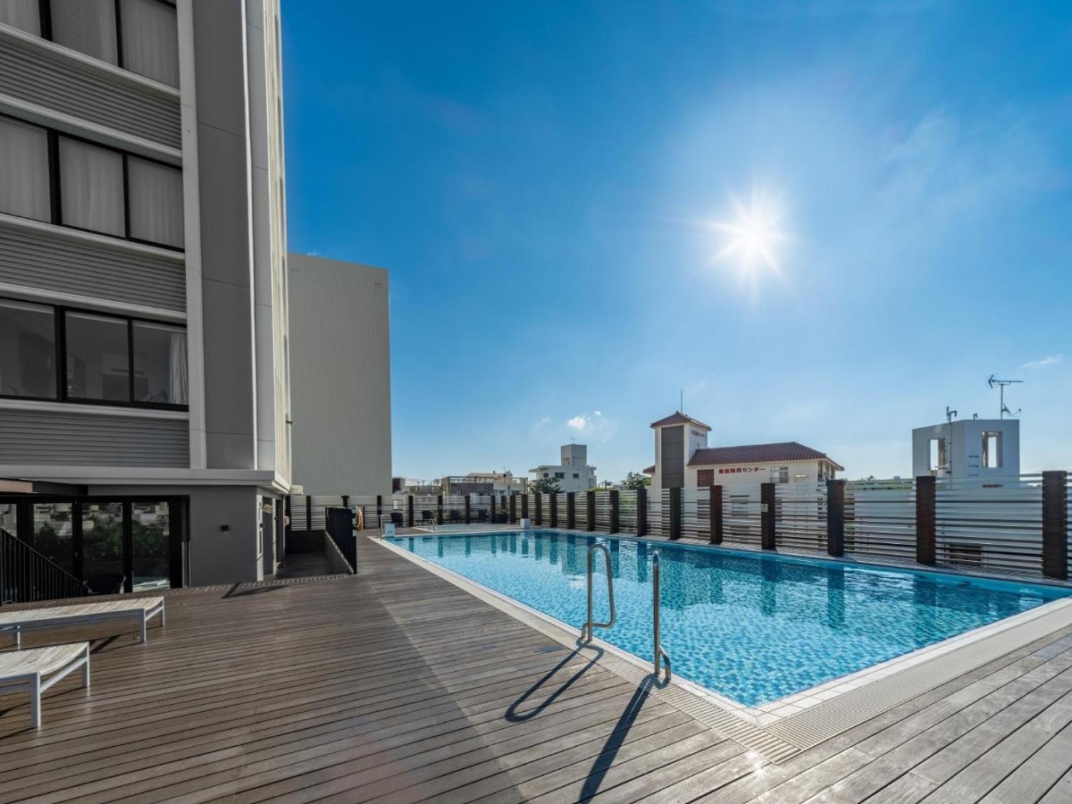 Rooftop-level pool at Hyatt Regency Naha, Okinawa with the city skyline behind