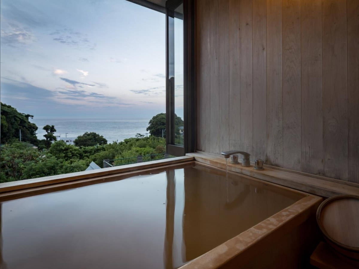 Hinoki open-air bath with a sea view in a King Room at Isaribi