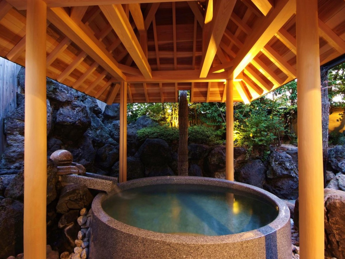 Stone tub in a wooden gazebo at Onishiya Suishoen