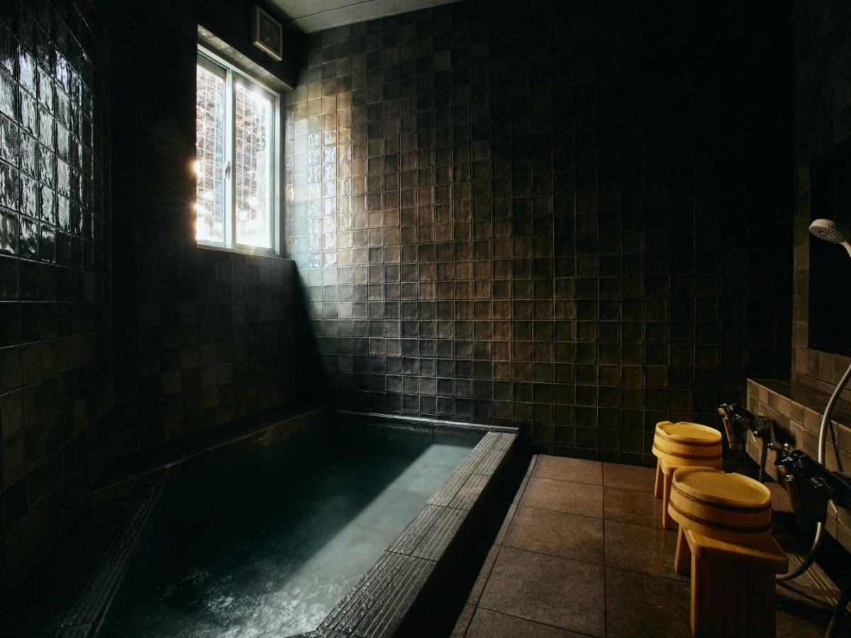 Stone bath with a window at Tsuchiya Kinosaki Onsen
