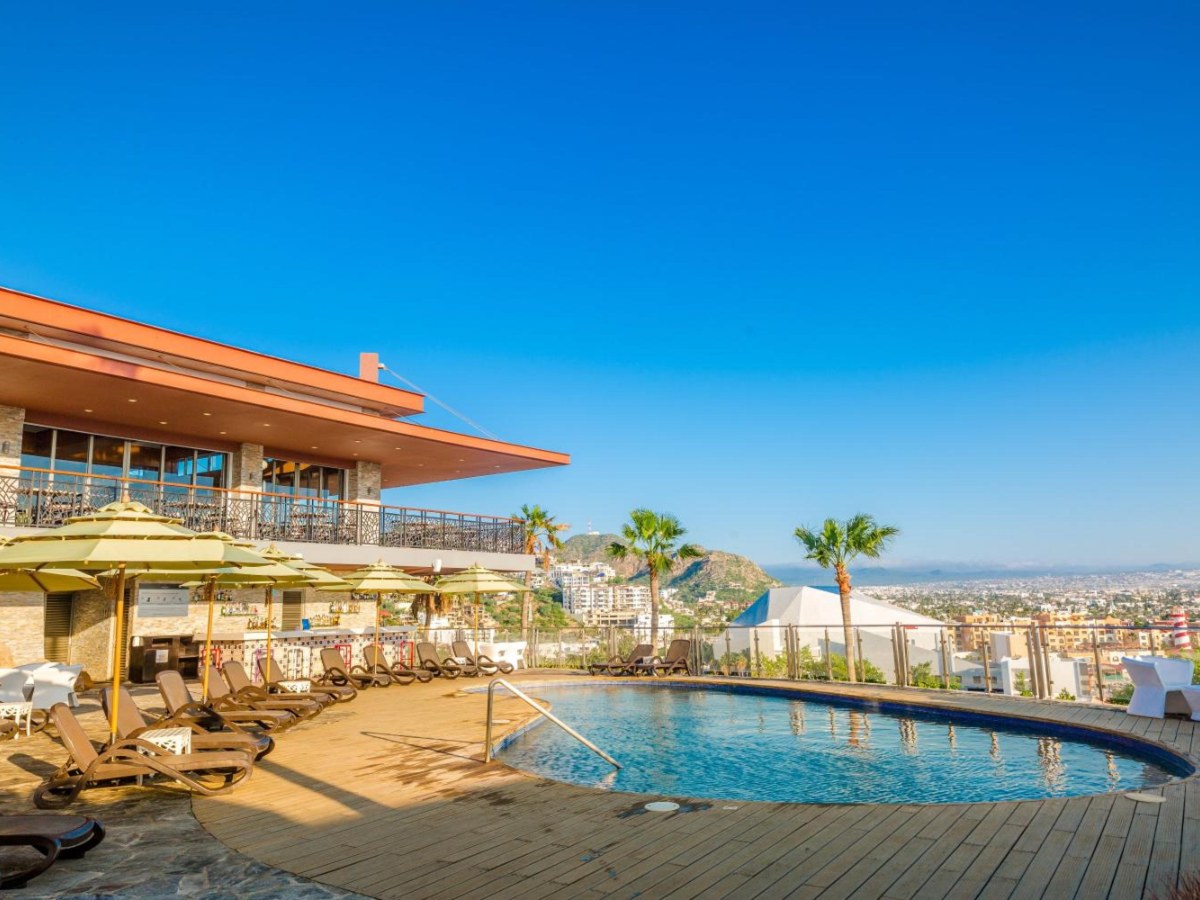 Resort pool with loungers at Sandos Finisterra in Cabo San Lucas