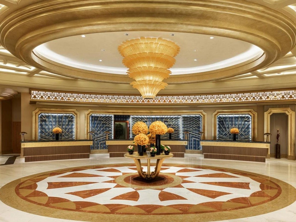 High-ceilinged lobby with a chandelier at Studio City Hotel
