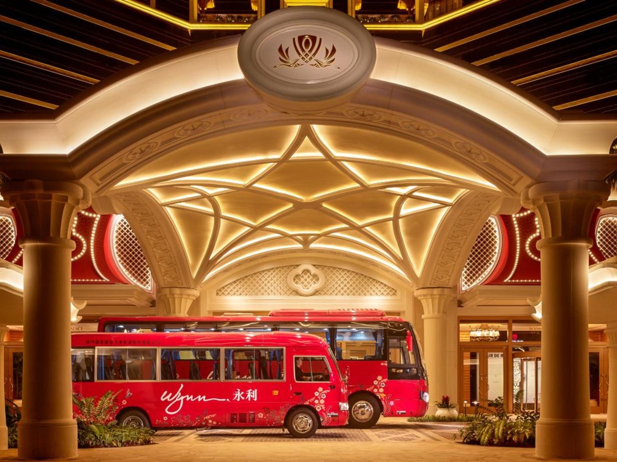 Red bus parked inside the grand hall at Wynn Palace