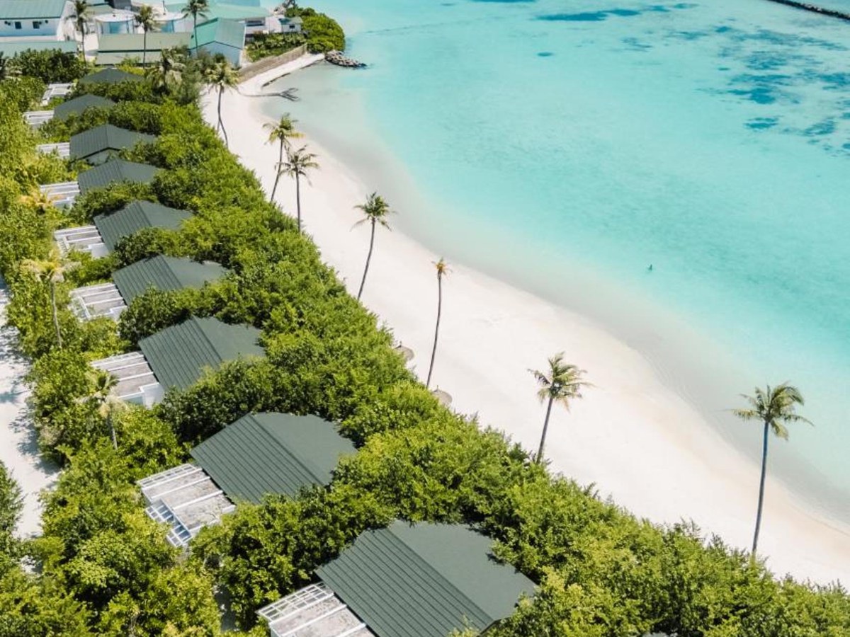 Family Beach Villas in a row beside the white beach and lagoon at Joy Island Maldives