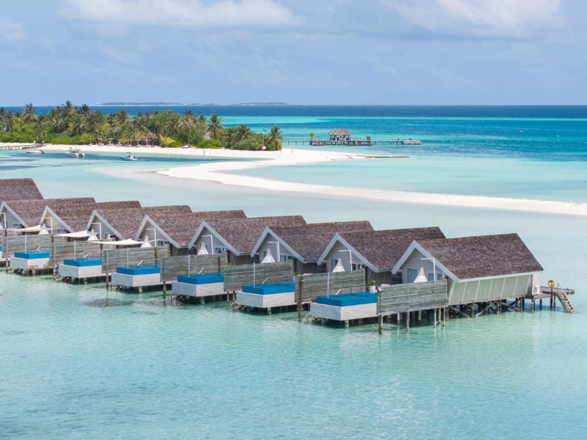 Row of overwater villas over the lagoon at LUX* South Ari Atoll Resort & Villas