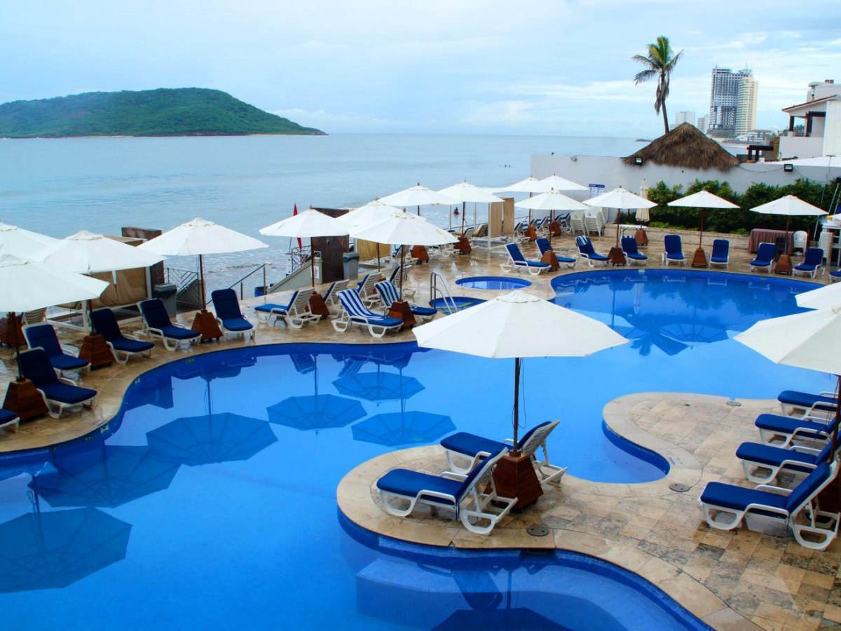 Oceanfront pool with umbrellas at Royal Villas Resort