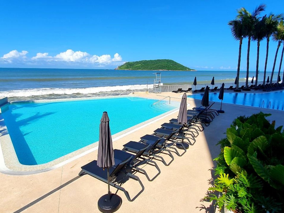 Beachfront pool with sun loungers at Viaggio Resort Mazatlán