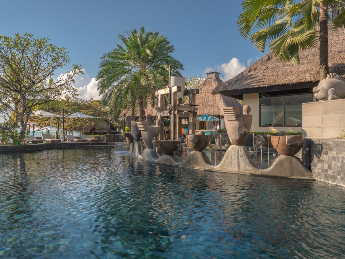Pool and rock features with resort buildings behind at Holiday Inn Resort Bali Nusa Dua