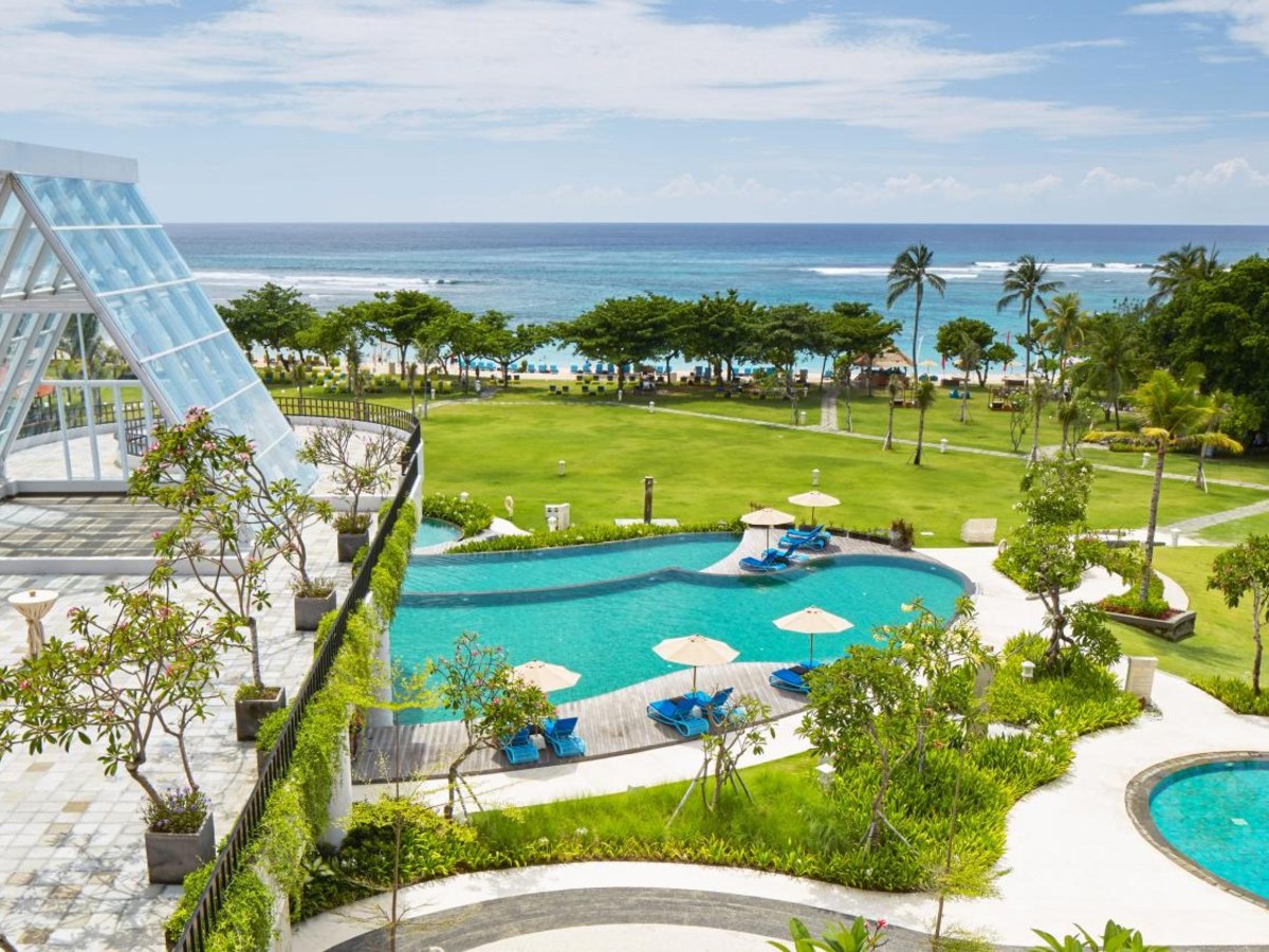 Aerial view of the main pool and the ocean at MERUSAKA Nusa Dua