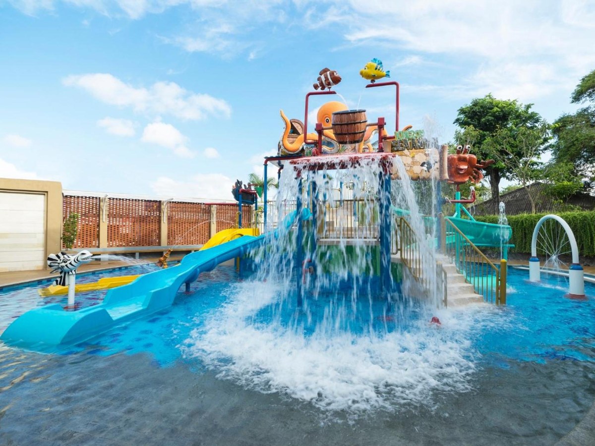 Kids water park with slides and a water bucket at Grand Mirage Resort