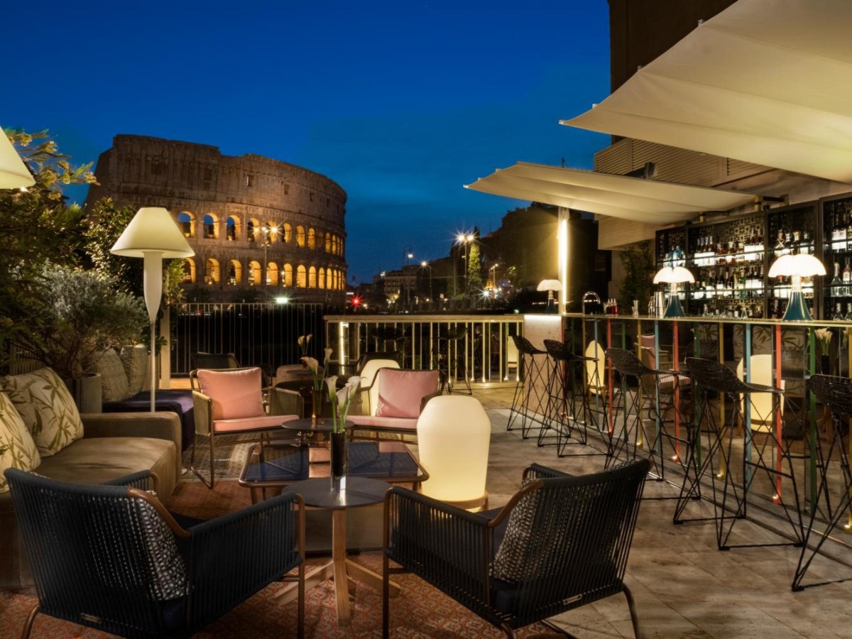 Palazzo Manfredi terrace at dusk with the lit Colosseum behind