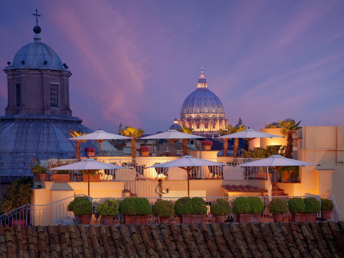 Hotel Raphaël rooftop terrace at dusk, with domes on the skyline