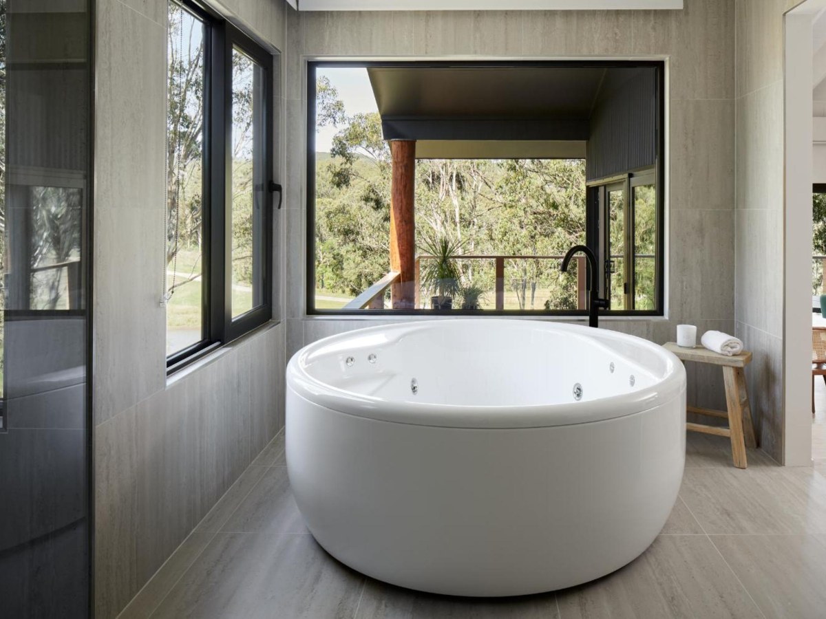 Spa bath for two under the window in the Treehouse bathroom at Cedars Mount View