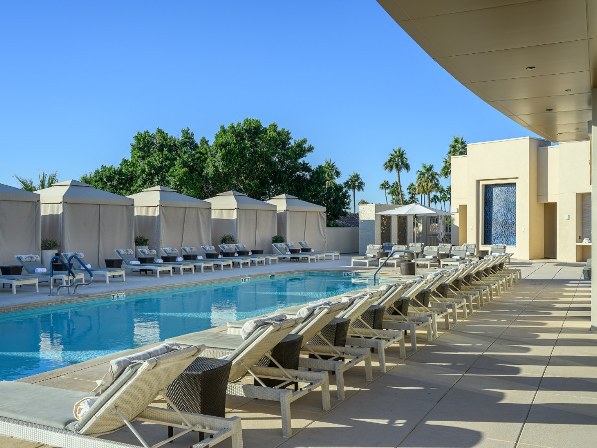 Rooftop spa pool lined with loungers and cabanas at The Phoenician