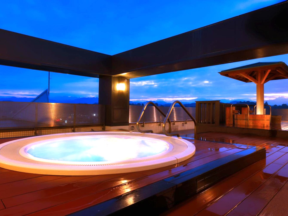 Rooftop open-air bath at dusk at Hida Hotel Plaza