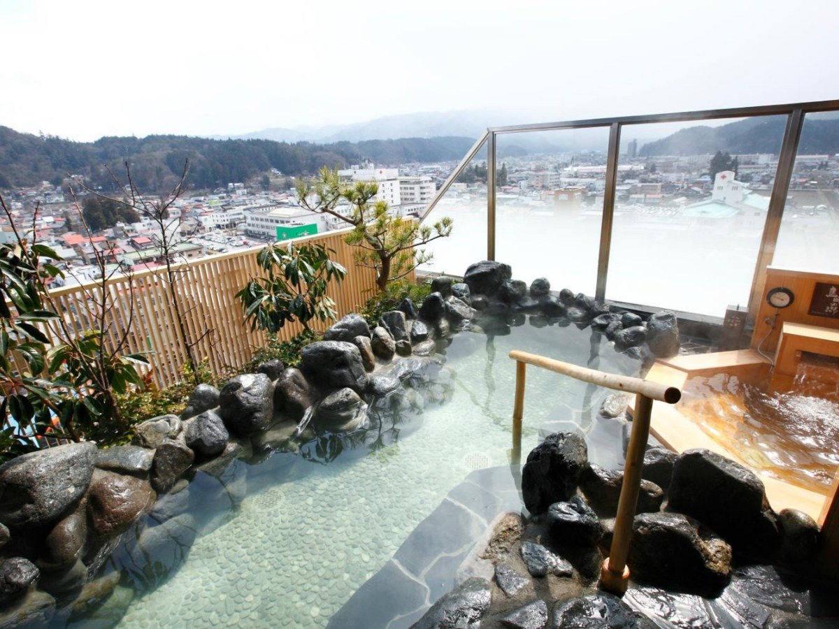 Rock open-air bath overlooking the city at Takayama Ouan