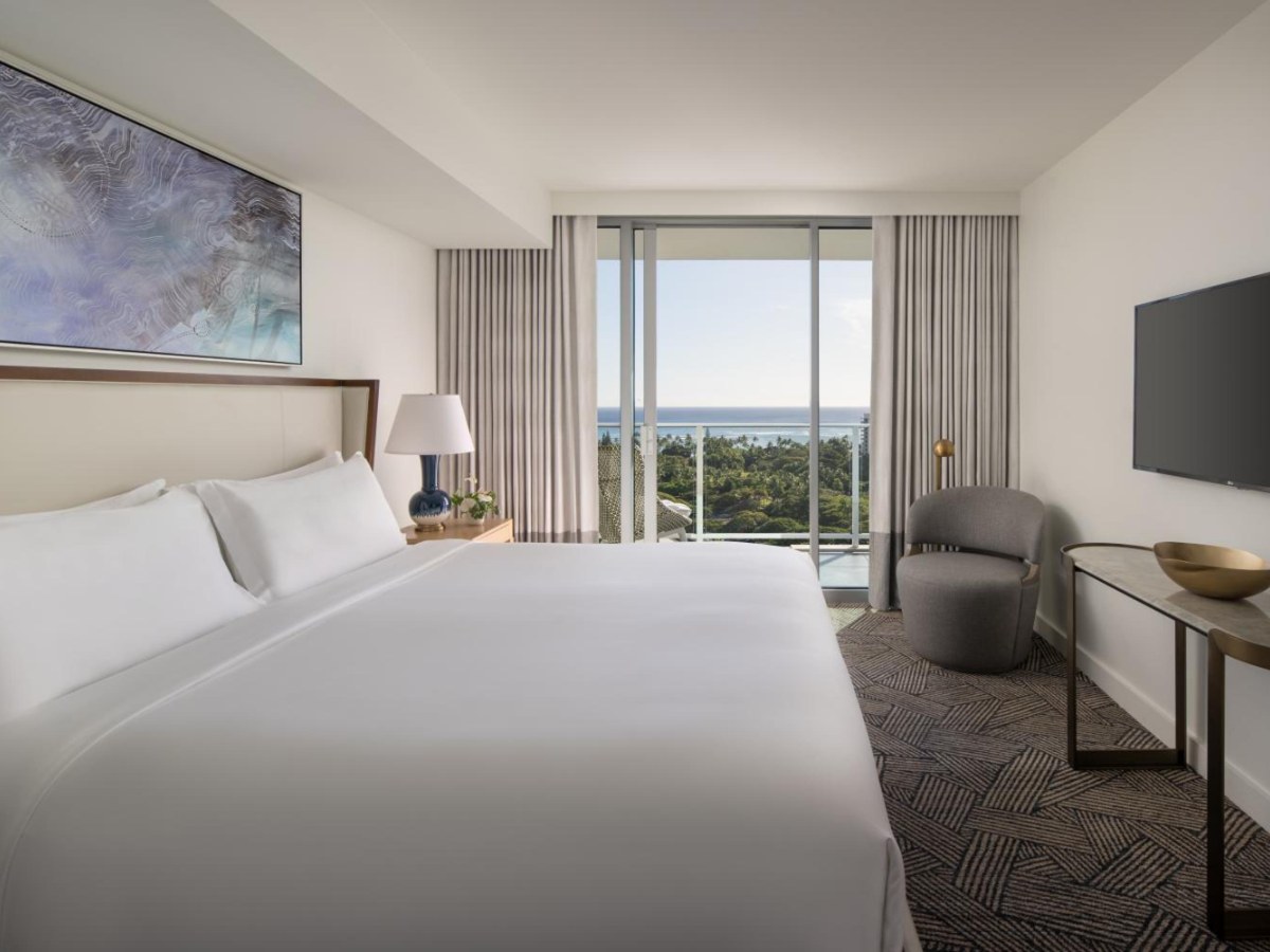 Large bed and television in a Ritz-Carlton Residences Waikiki Beach two-bedroom suite